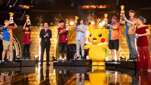 Champions holding trophies on stage with a Pikachu mascot at the 2026 Pokemon World Championships closing ceremony in San Francisco