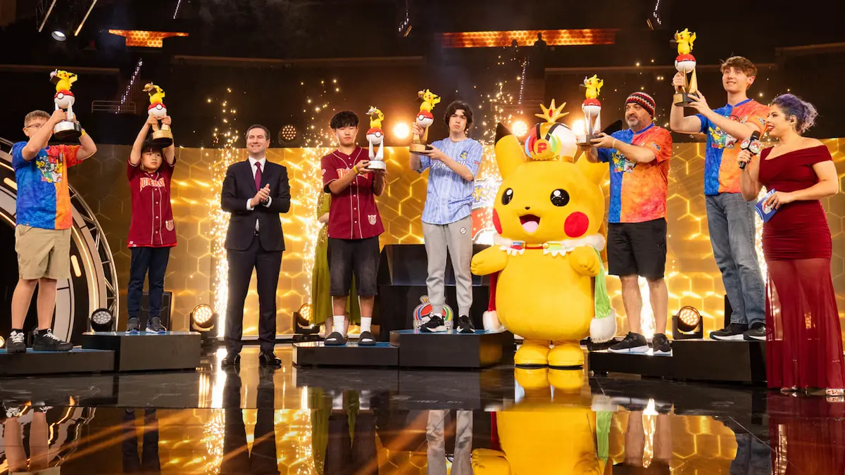 Champions holding trophies on stage with a Pikachu mascot at the 2026 Pokemon World Championships closing ceremony in San Francisco