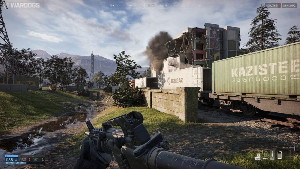Wardogs gameplay showing in game cash HUD, health bar, and a destructible building near a rail yard